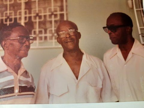 His father, Vincent — centre — who ran the family pharmacy in Trinidad