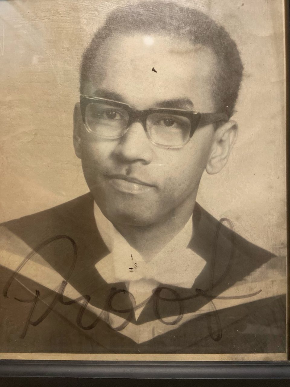 Young Gabriel in his University of Guelph graduation gown, 1972, signed across the front of the portrait